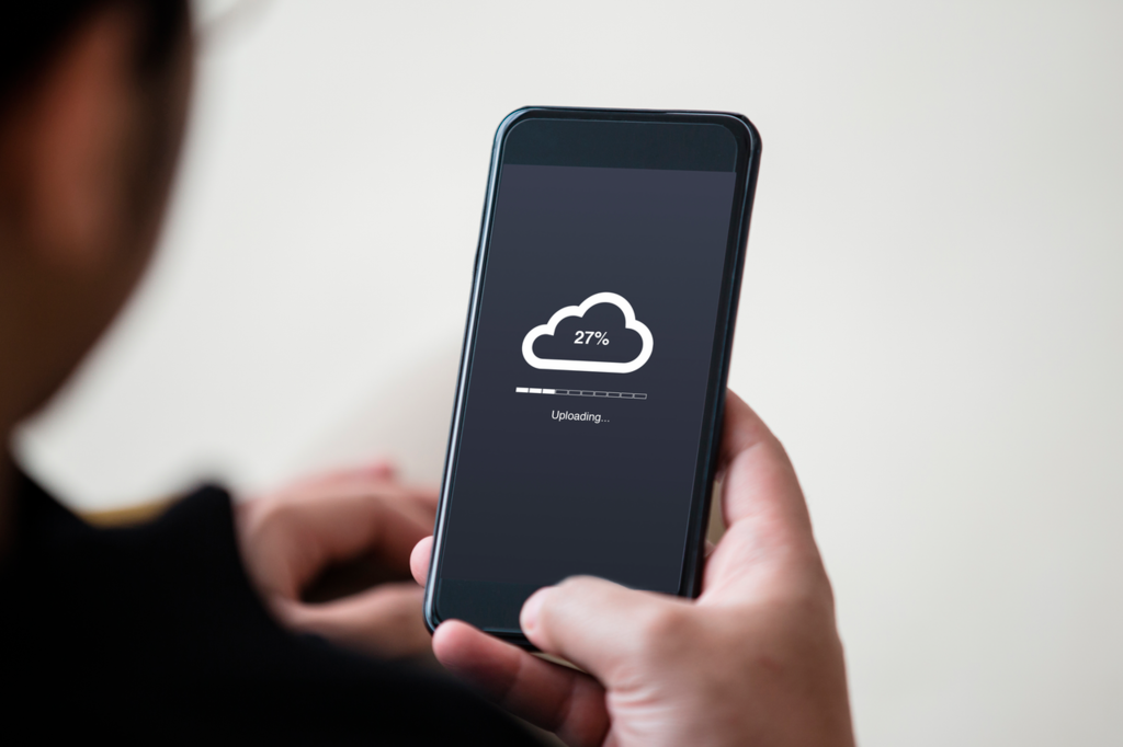 Momentum_Cloud_uploading_concept_on_phone_screen._Man_hand_hold_phone_doing_cloud_uploading.-low-res.png
