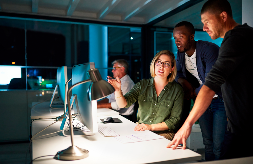 Momentum_Team of people working in dark room.png